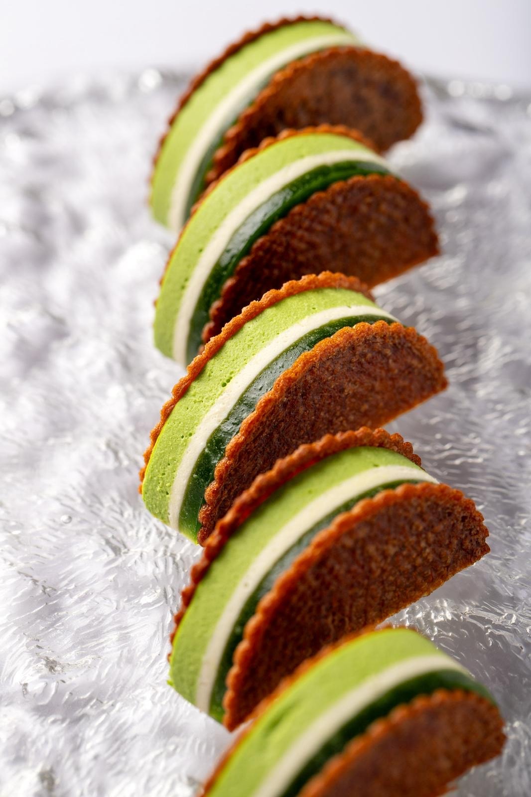 Green matcha macarons in a row
