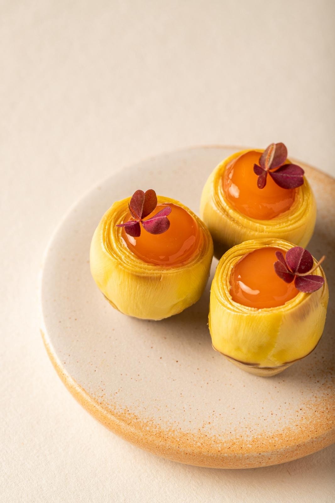Yellow dome desserts with orange glaze