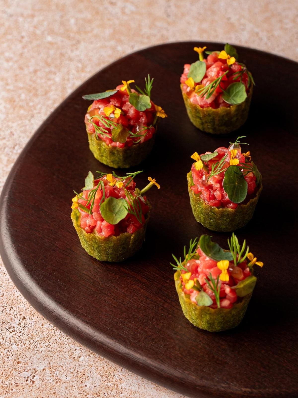 Carrot and caviar canapés on grain bed